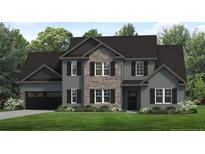 Two-story house with gray siding, stone accents, and a three-car garage at 37 Pomegranate Ct, Cameron, NC 28326