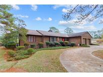 Brick ranch home with attached garage and landscaped yard at 48 Indian Trl, Sanford, NC 27332