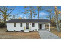 Newly renovated single-story home with a carport and landscaped yard at 189 Zenobia Ave, Lillington, NC 27546