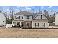 Two-story house with gray siding, stone accents, and a landscaped yard at 192 Rosslyn Chapel Ln, Cameron, NC 28394