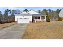 Charming single Gathering home with well-maintained lawn and attached two car garage at 240 Colonial Hills Drive Dr, Lillington, NC 27546