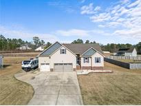 Charming home with three-car garage and large driveway with room for parking a camper at 81 Jaylin Blvd, Spring Lake, NC 28390