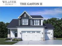 Two-story home with gray and white exterior, three-car garage, and landscaping at 117 Boyce Ct, Sanford, NC 27332