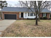 Brick ranch house with attached garage and landscaping at 128 Highland Dr, Lillington, NC 27546