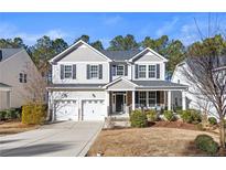 Two-story house with gray siding, white trim, and a stone facade at 597 Micahs N Way, Spring Lake, NC 28390