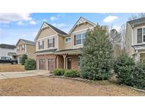 Charming two-story home with a brick and siding exterior, complemented by a well-maintained front yard at 323 River Oak St, Spring Lake, NC 28390