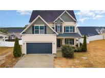 Charming two-story home featuring a two-car garage and manicured front yard at 638 Century Dr, Cameron, NC 28326