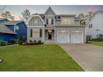 Charming two-story home showcasing a manicured lawn and a two-car garage at 87 Education Dr, Spring Lake, NC 28390