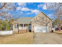 Charming single-Gathering home featuring a two-car garage and covered front porch at 10 Tory Ct, Lillington, NC 27546