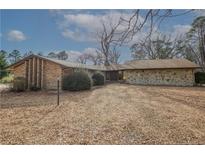 Ranch style home, featuring brick and stone exterior with an extended driveway and mature trees at 1468 Union Church Rd, Cameron, NC 28326