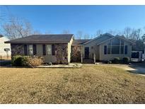 Charming single-story home showcasing a stone and siding facade, surrounded by a neat lawn at 1501 Homestead Rd, Rocky Mount, NC 27804