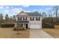 Charming two-story home featuring a classic design, attached two-car garage, and well-maintained front lawn at 262 Shepard Dr, Linden, NC 28356