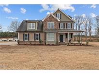 Two story home featuring stone accents and a covered porch at 31 White Tail Path, Erwin, NC 28339