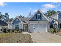 Charming single-Gathering home with a well-manicured lawn and attached two-car garage at 159 Glenwood Ct, Spring Lake, NC 28390