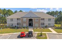 Apartment building with stone accents, well-maintained landscaping, and ample parking space at 240 Gallery Dr # 201, Spring Lake, NC 28390