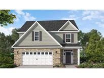 Charming two-story home with stone accents, a two-car garage, neutral siding and a classic, covered entryway at 265 Harborwood St, Lillington, NC 27546