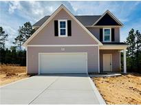 Charming two-story home with a two-car garage, covered entryway, and freshly poured driveway at 265 Harborwood St, Lillington, NC 27546