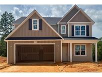 Charming two-story home with a two-car garage and a combination of vertical and horizontal siding at 293 Harborwood St, Lillington, NC 27546