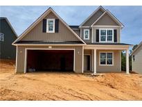 Charming two-story home featuring a spacious garage, complemented by a neutral-toned exterior and inviting curb appeal at 293 Harborwood St, Lillington, NC 27546