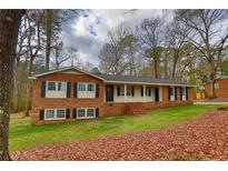 Charming brick home with a well-maintained lawn and inviting front porch, perfect for relaxing outdoors at 374 S Denise Ave, Coats, NC 27521