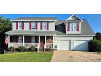Charming two-story home with a brick-accented porch, two-car garage, and a well-manicured front lawn at 11 Scotland Dr, Spring Lake, NC 28390