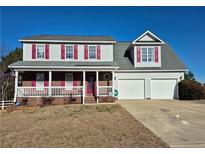 Charming two-story home featuring a covered porch and a spacious two-car garage at 11 Scotland Dr, Spring Lake, NC 28390