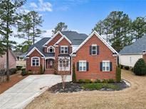 Charming red brick home featuring black shutters and a well-manicured front yard at 127 Skipping Water Dr, Spring Lake, NC 28390