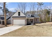 Charming one-story home features a two-car garage and a well-manicured lawn at 1824 Irish Blvd, Sanford, NC 27332