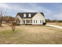 Charming two-story home with a symmetrical facade, dormer windows, and a well-manicured lawn at 302 Mar Joy Dr, Dunn, NC 28334