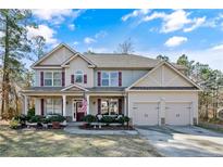 Charming two-story home features a manicured lawn, covered front porch, and attached two car garage at 968 Coachman Way, Sanford, NC 27332