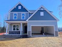 Charming two-story home with blue and gray siding and a spacious two-car garage at 22 Peach Orchard (Lot 1) Ln, Lillington, NC 27546