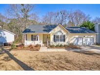 Charming single-Gathering home showcasing a well-manicured front yard and attached two-car garage at 273 Coachman Way, Sanford, NC 27332