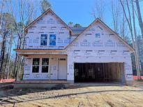 New home with windows, door, and garage during the final construction stages at 62 Peach Orchard (Lot 3) Ln, Lillington, NC 27546