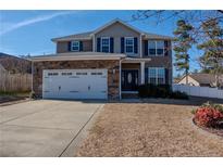 Charming two-story home featuring a two-car garage and well-maintained front lawn at 37 Annapolis Rd, Cameron, NC 28326