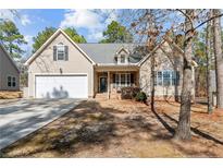 Charming one-story home featuring a two-car garage, well-manicured lawn, and inviting front porch at 45 Cutter Cir, Sanford, NC 27332