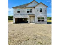 Unfinished two-story home featuring a two-car garage and traditional window design under a clear blue sky at 5554 Swanns Station Rd, Sanford, NC 27332