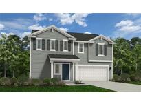 Charming two-story home features a manicured lawn, gray siding and a two car garage at 5572 Swanns Station Rd, Sanford, NC 27332