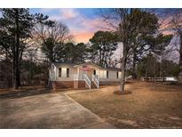 Charming single-story home with a welcoming front porch and well-maintained lawn at 14 Brafford Estates Dr, Cameron, NC 28326