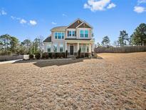 Charming two-story home with beautiful windows and a well-maintained front yard at 202 Heatherwood Dr, Lillington, NC 27546