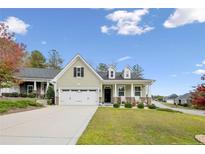 Charming single-Gathering home featuring a two-car garage, manicured lawn, and inviting front porch at 10 Glenside Ct, Spring Lake, NC 28390