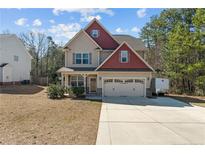 Two-story home with a two-car garage and a well-manicured lawn at 220 Pender Rd, Spring Lake, NC 28390