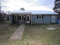 Charming single-story home features a metal roof and covered front porch at 6704 Deep River Rd, Sanford, NC 27330