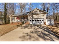 Charming single Gathering home featuring a two-car garage and a quaint front porch area at 7053 Maple Cir, Sanford, NC 27332