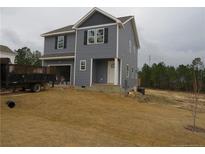 Charming two-story home with gray siding, black shutters and an attached garage at 932 Allstar Ave, Cameron, NC 28326