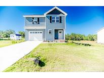 Charming two-story home with light-blue siding and a well-maintained lawn at 932 Allstar Ave, Cameron, NC 28326