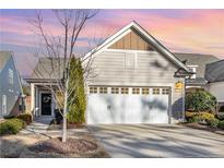 Charming home featuring a two-car garage, well-manicured lawn, and inviting front entrance at 1111 Axelwood Ln, Durham, NC 27703