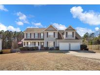 Charming two-story home with a two-car garage and well-maintained landscaping at 192 Checkmate Ct, Cameron, NC 28326