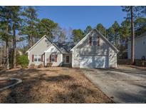 Charming single-Gathering home with a two-car garage and lush landscaping, nestled in a quiet neighborhood at 48 Cedar Ln, Sanford, NC 27332
