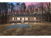 Ranch style home with tan siding, black shutters, new landscaping and a screened in porch at 9349 Perry Rd, Graham, NC 27253