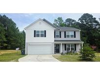 Charming two-story home with a well-maintained front yard and a two-car garage at 15 Summerwood Ln, Lillington, NC 27546